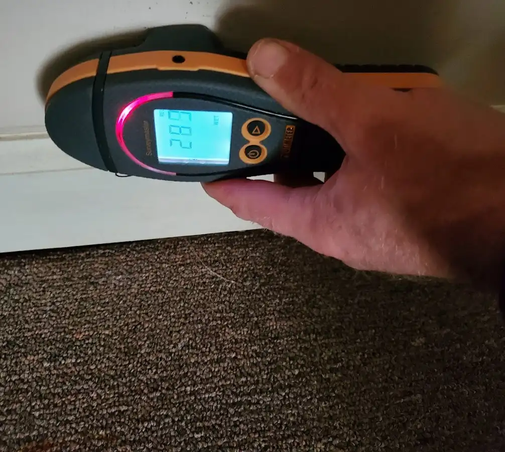 Moisture detection at baseboard during Storm Damage Restoration in Floresville